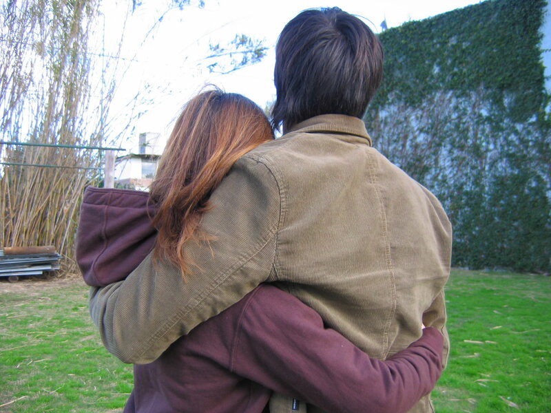couple hugging in backyard