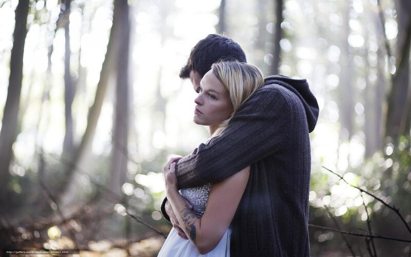 Couple hugging in forest