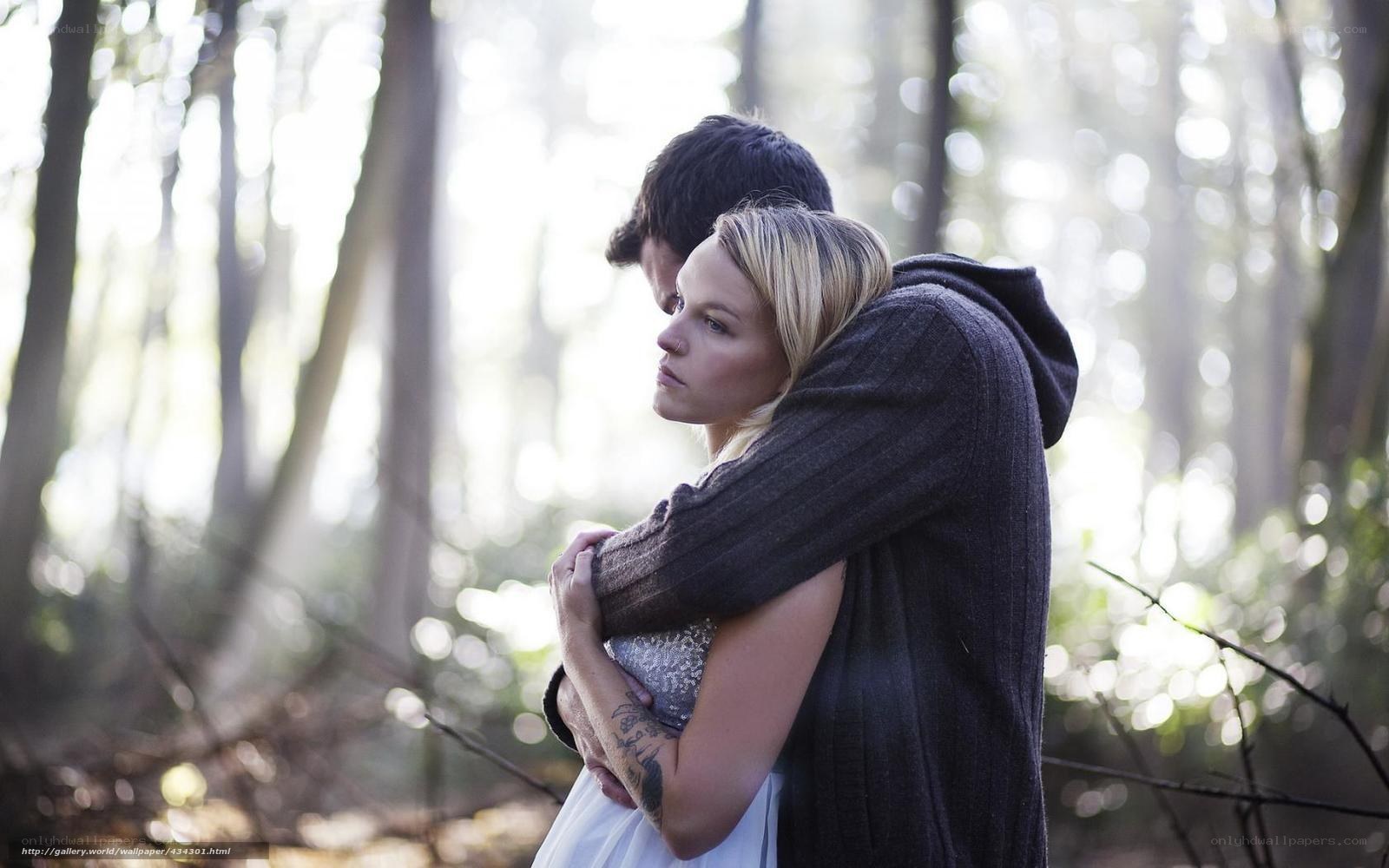 Couple hugging in forest