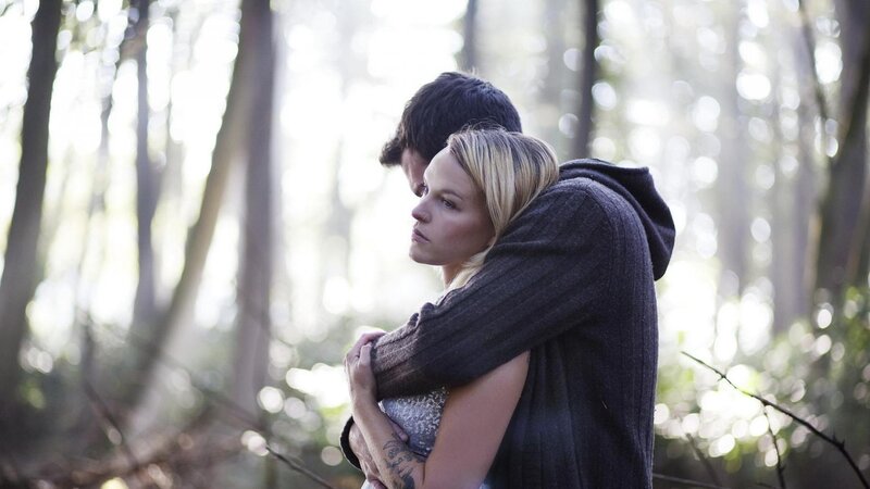 Couple hugging in forest