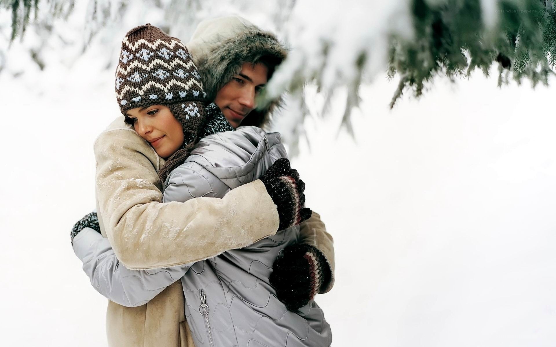 Couple hugging in snowy forest