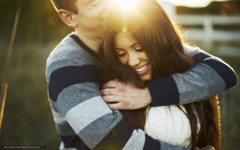 Couple hugging in sunlight
