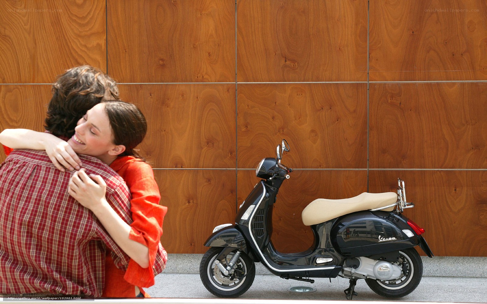 Couple hugging near scooter