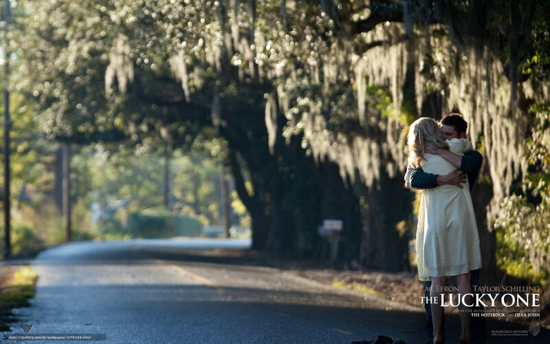 couple hugging on a tree-lined road