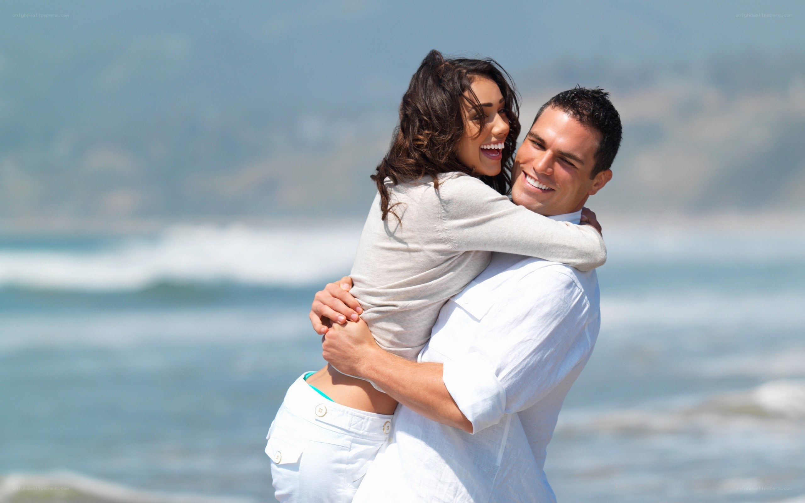 Couple hugging on the beach