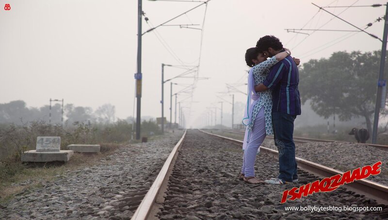 couple hugging on train tracks