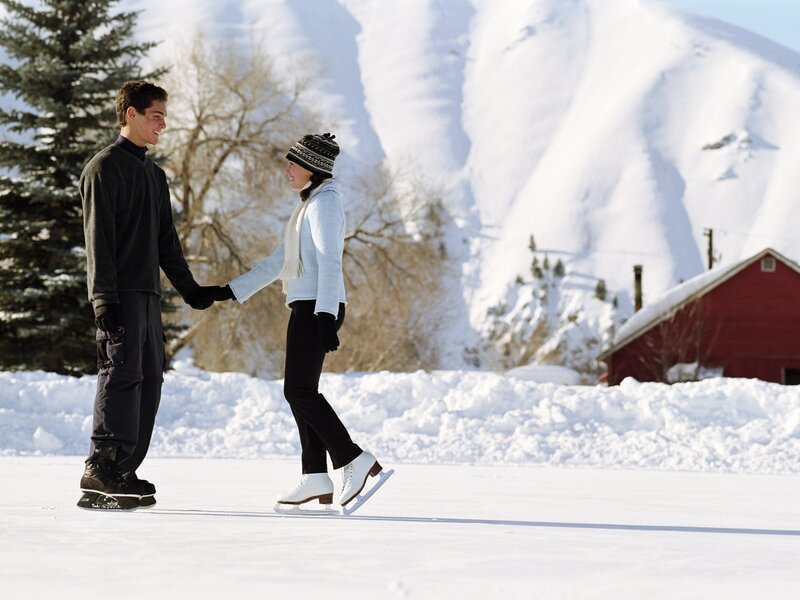 Couple ice skating in winter