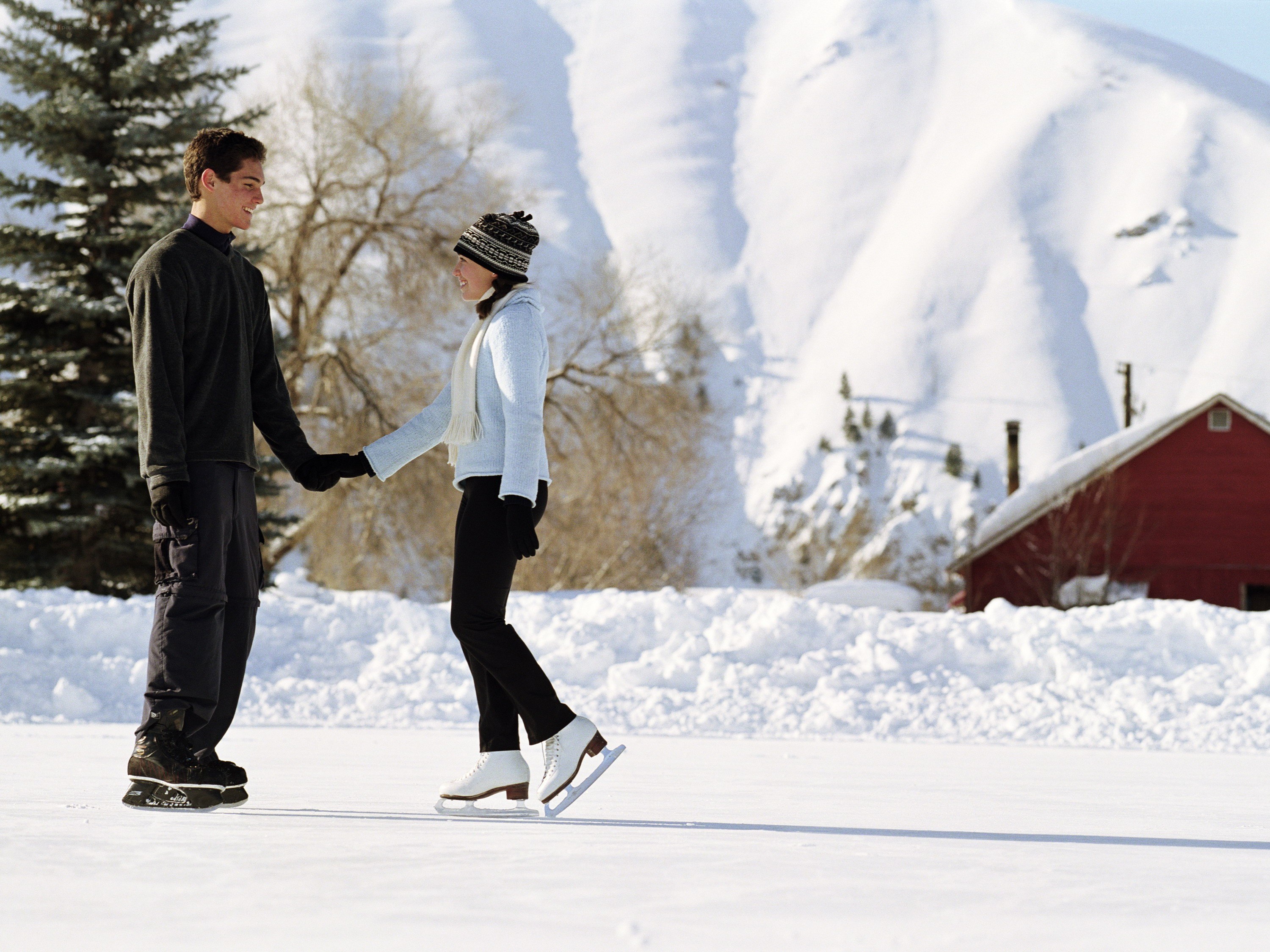 Couple ice skating in winter