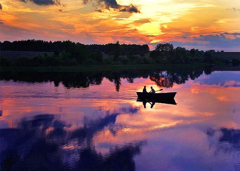 Couple in a boat at sunset