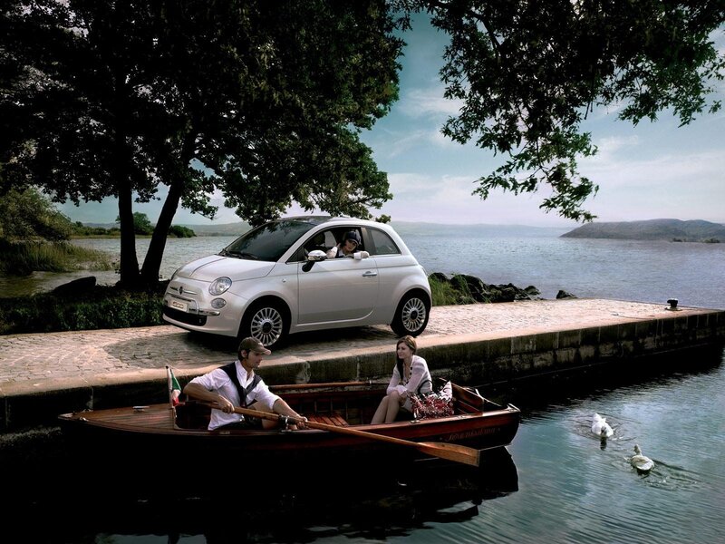 Couple in a boat near a car