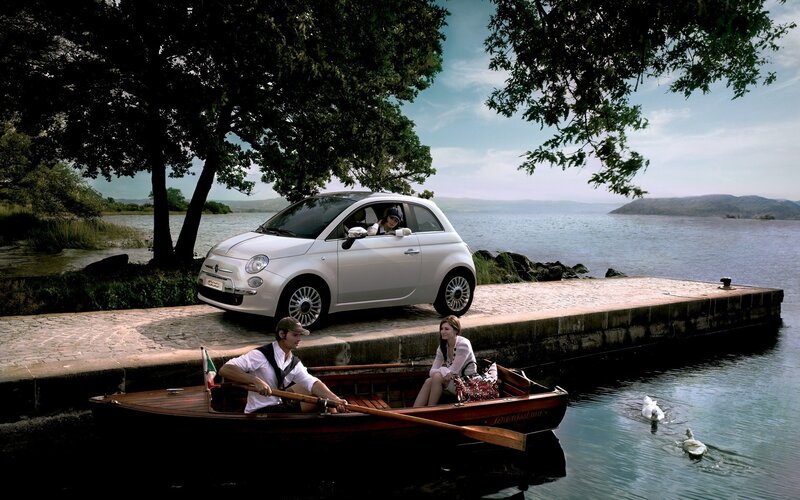 Couple in a boat near a car