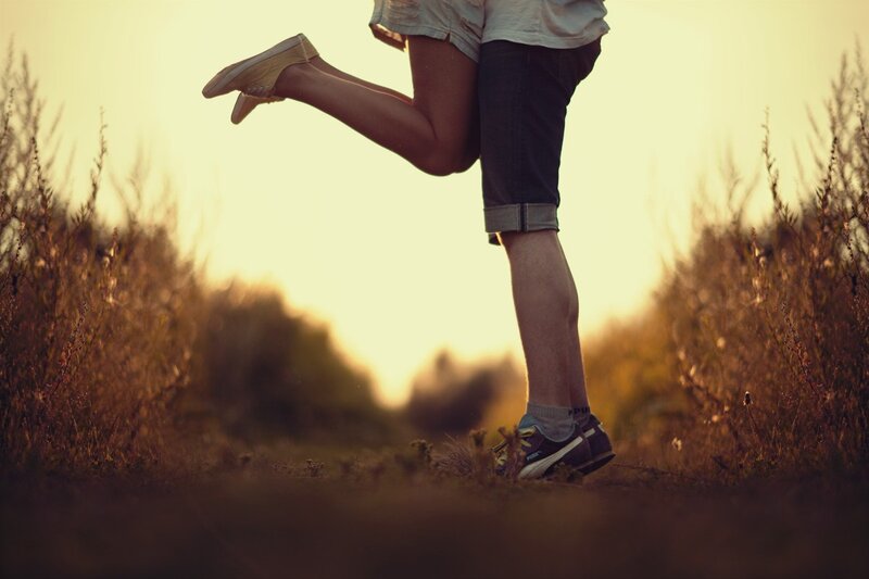 couple in a field at sunset