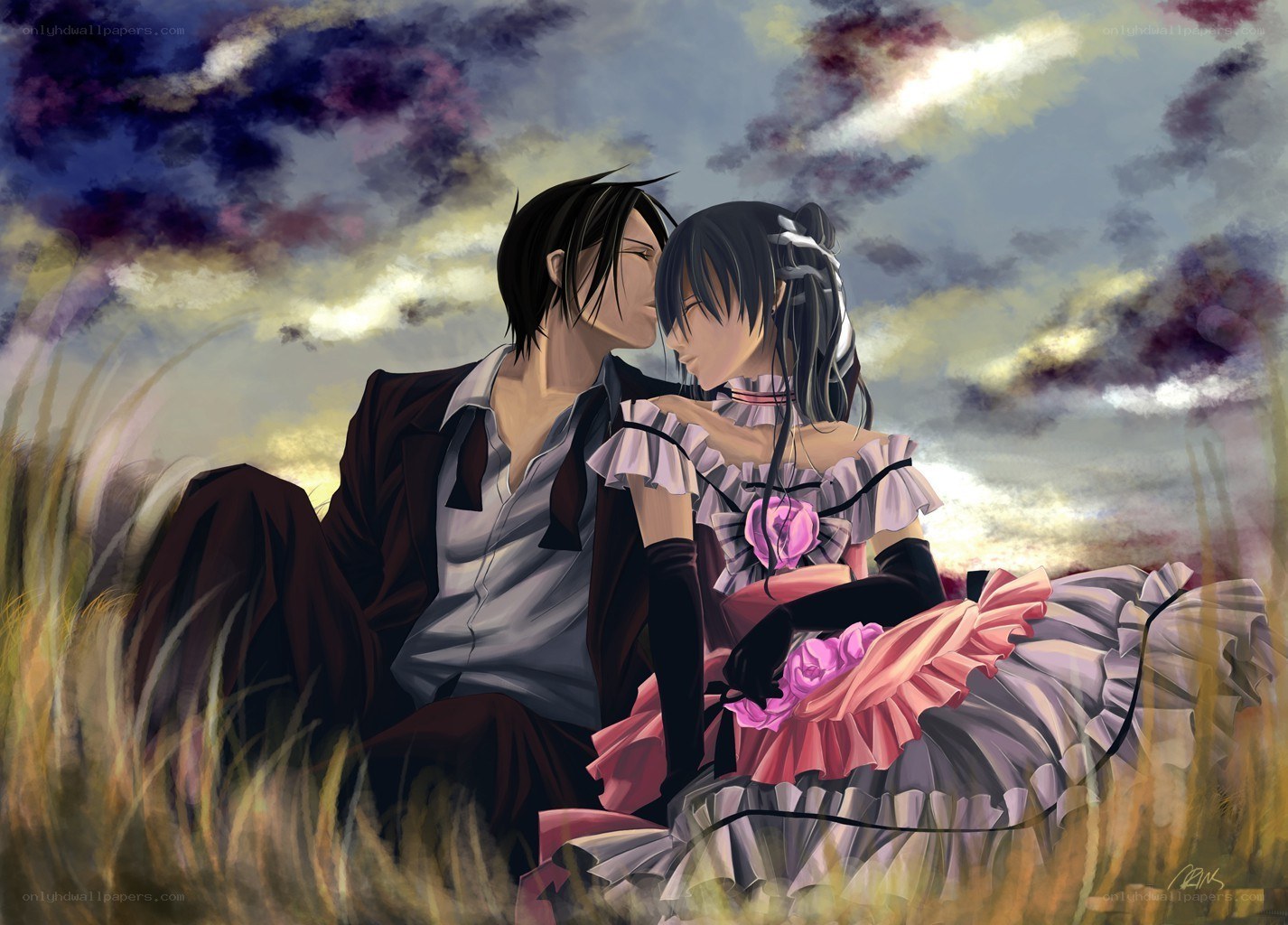 couple in a field at sunset