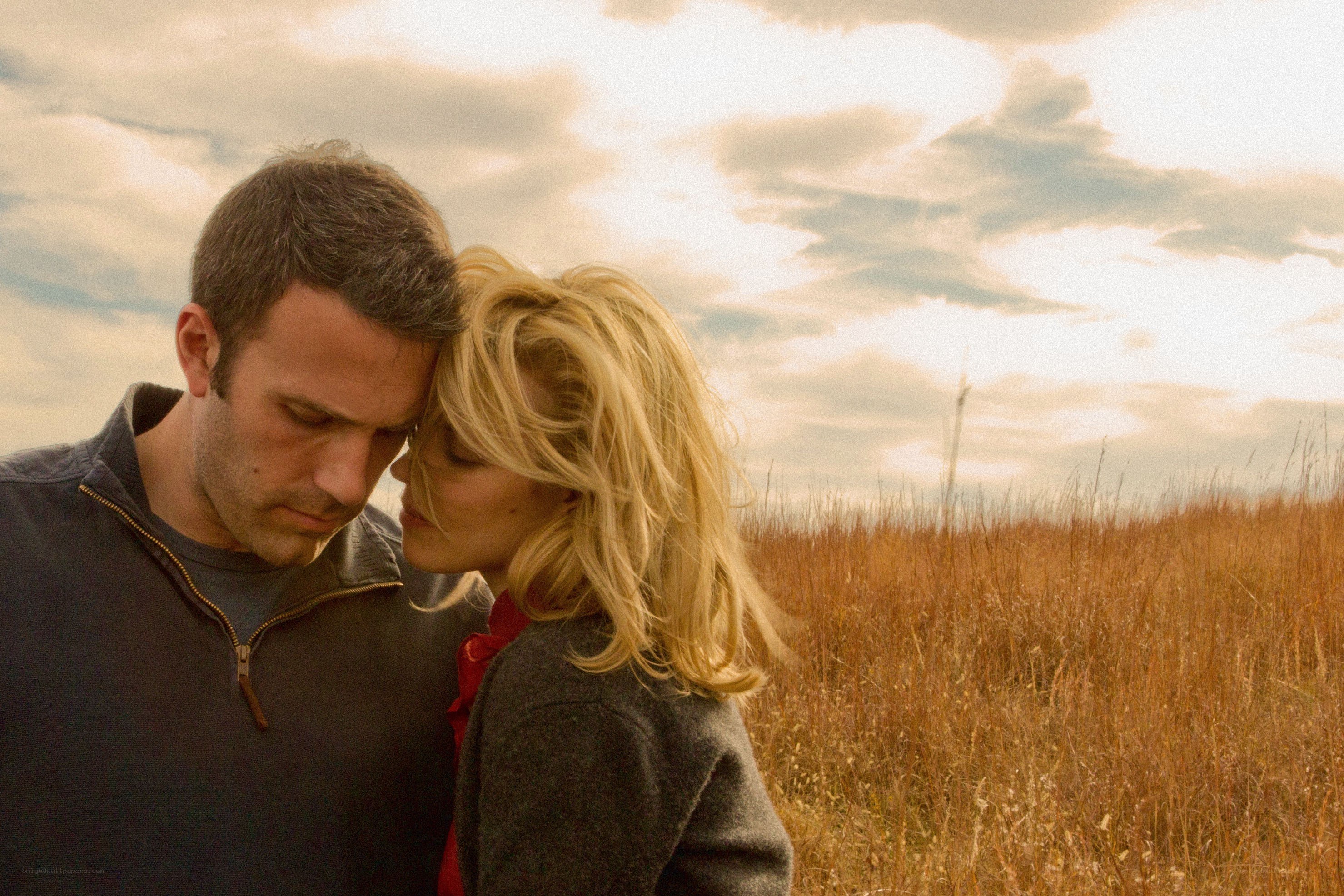 couple in a field at sunset