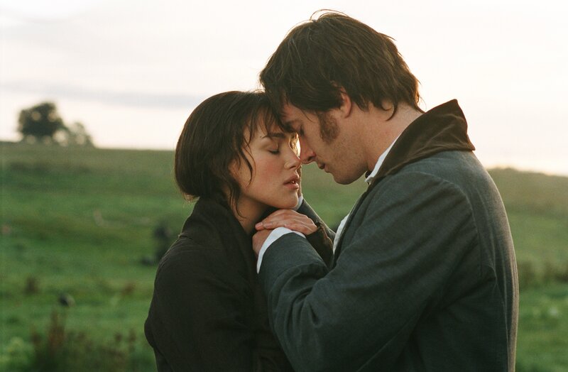 couple in a field embrace