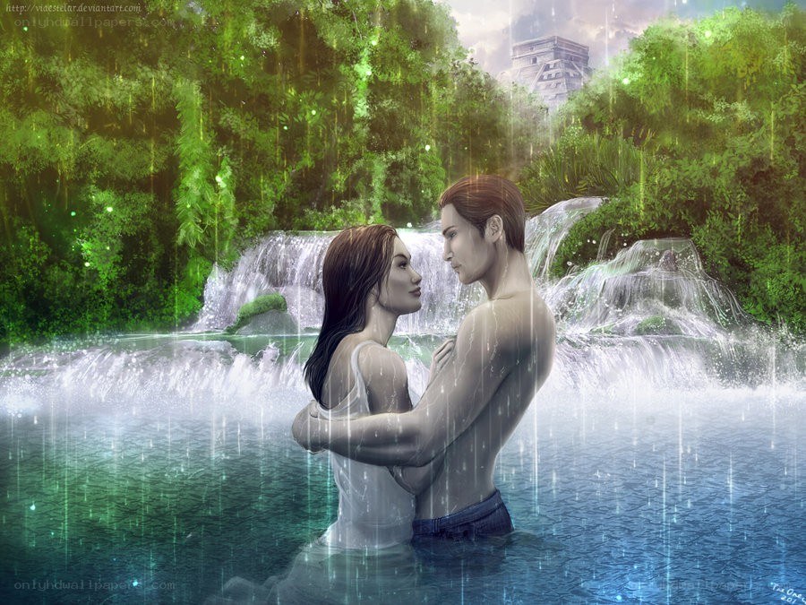 Couple in a rainforest waterfall