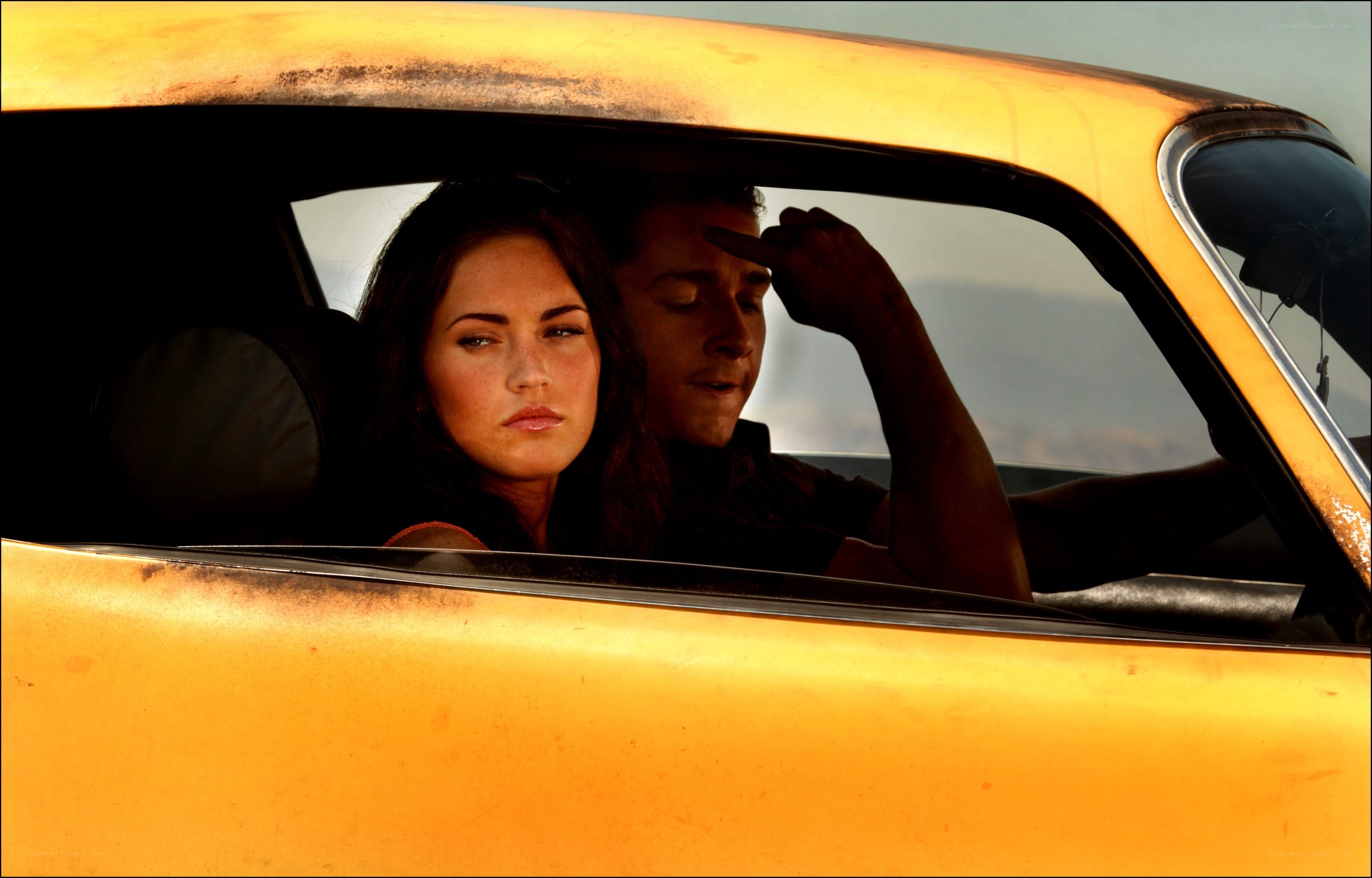Couple in a yellow car