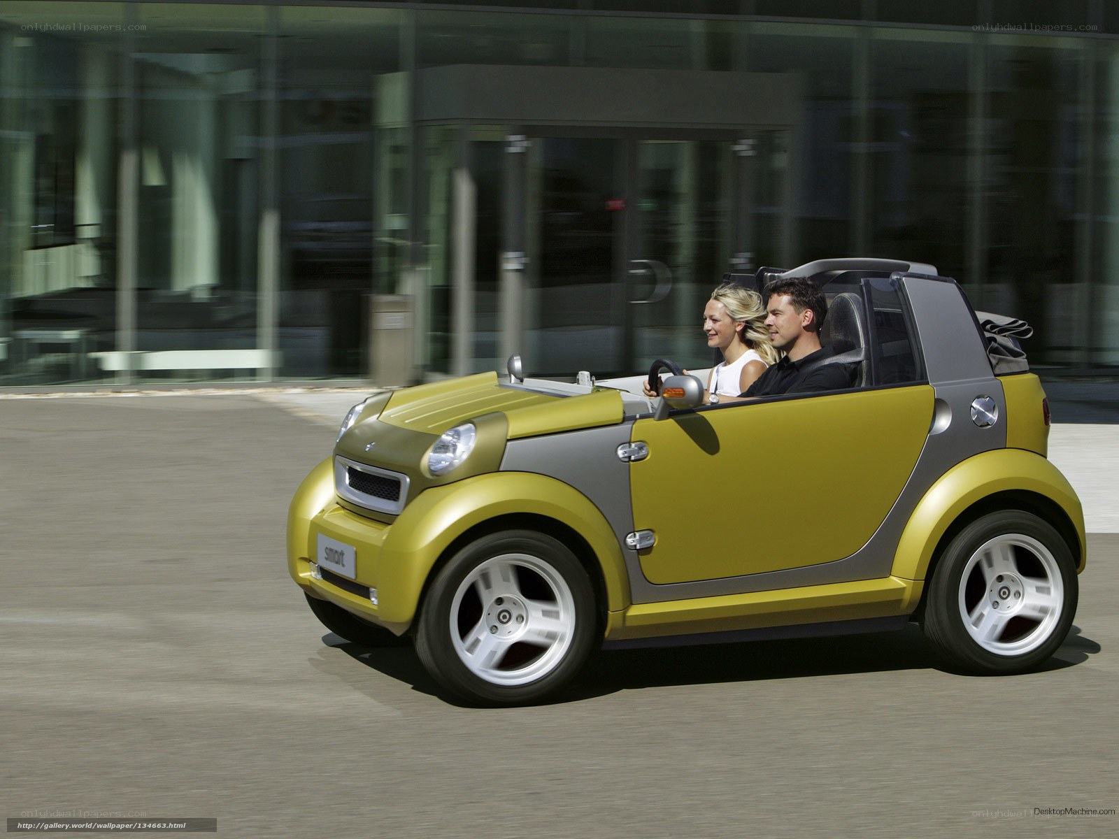 Couple in a yellow smart car