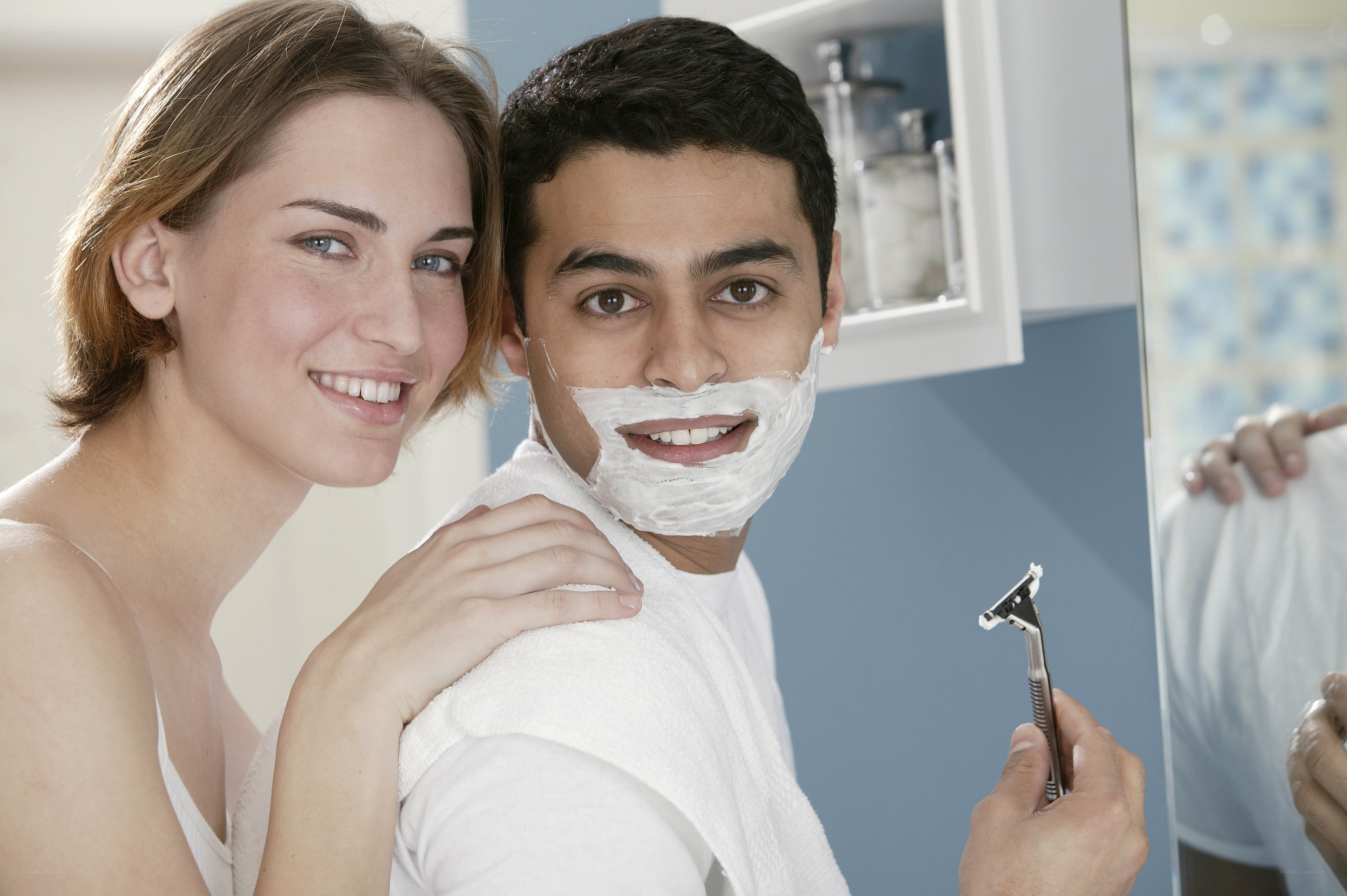 Couple in bathroom shaving