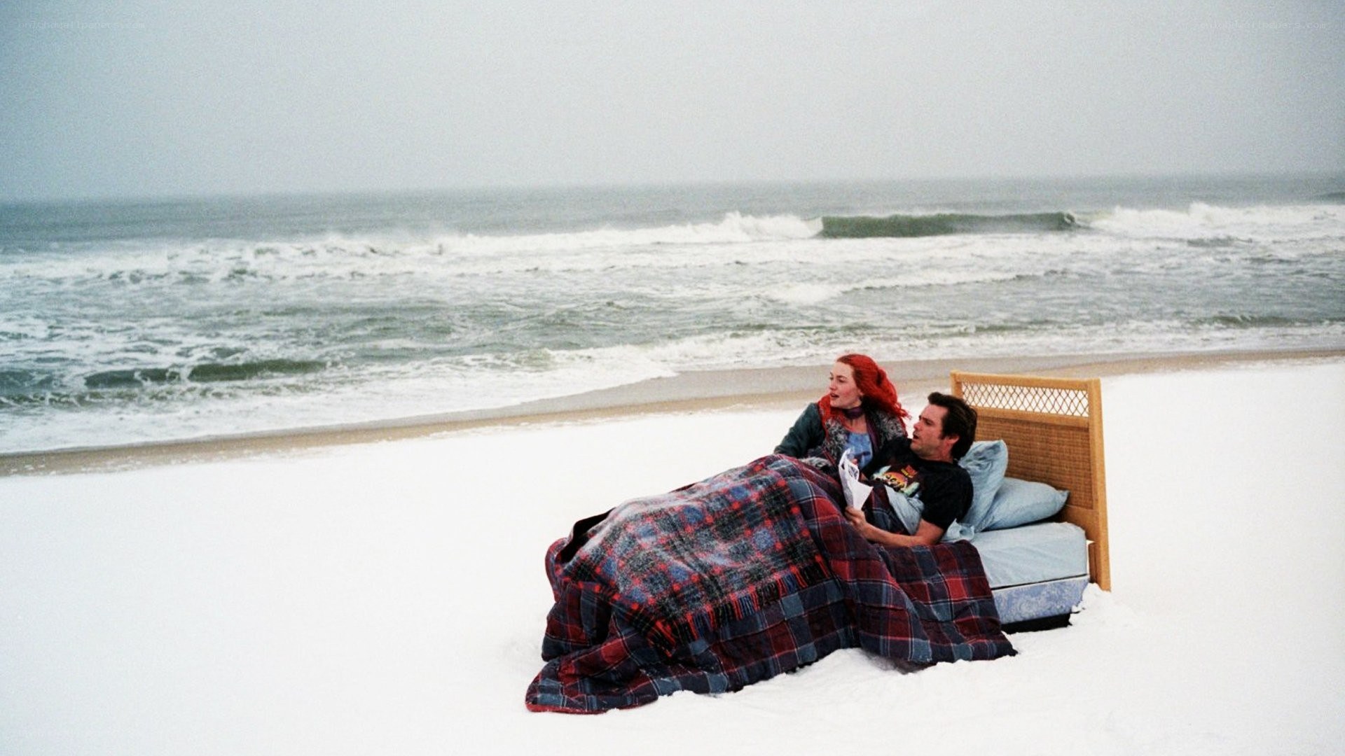 Couple in bed on snowy beach