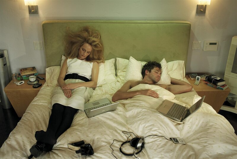 Couple in bed with laptops