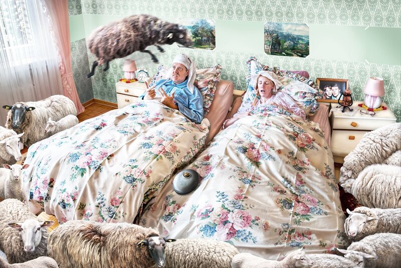 Couple in bed with sheep