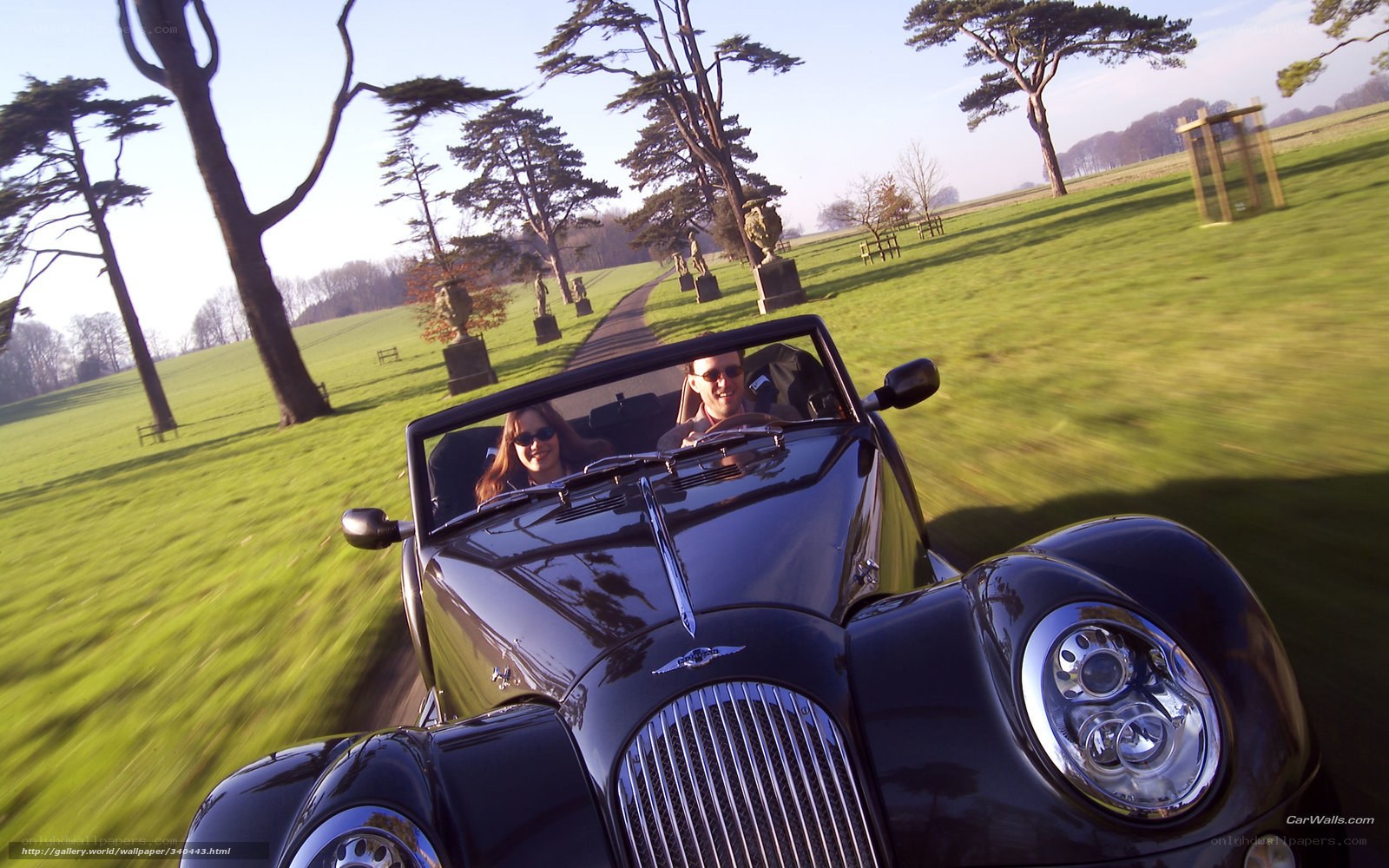 Couple in classic convertible car