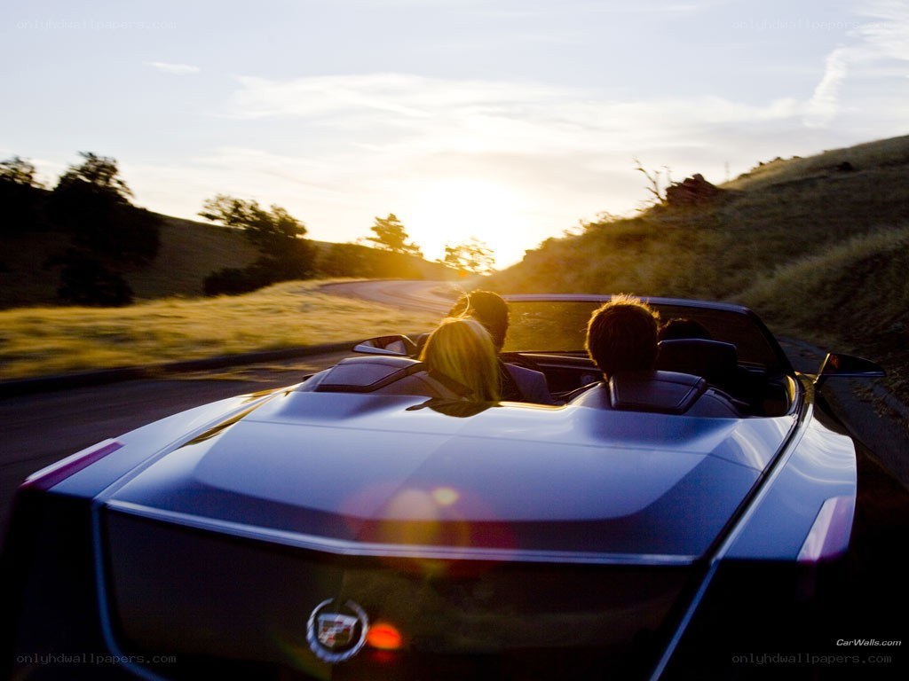 Couple in convertible at sunset