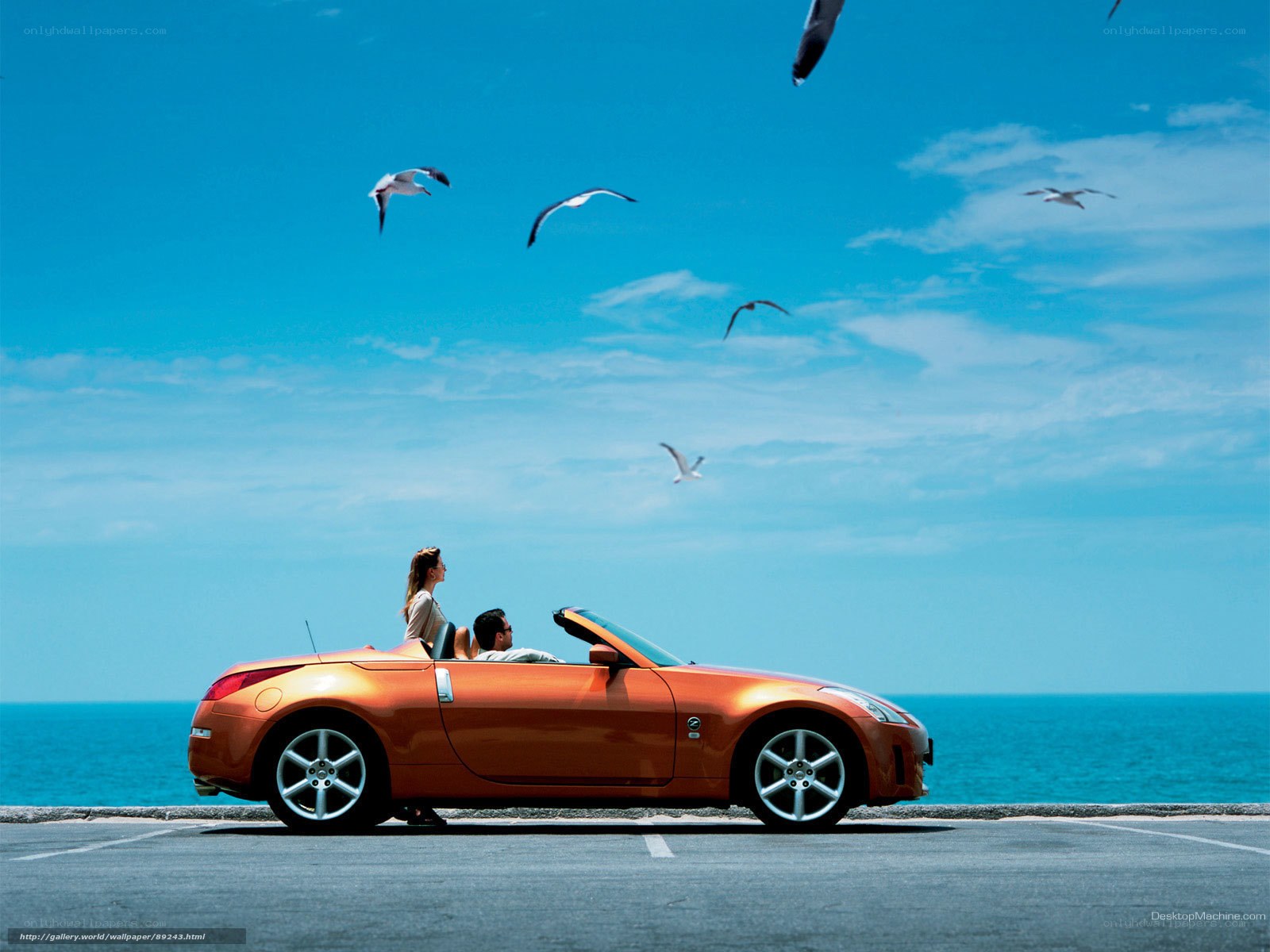 Couple in convertible by the sea