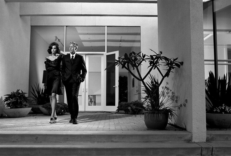 Couple in formal wear outside modern home