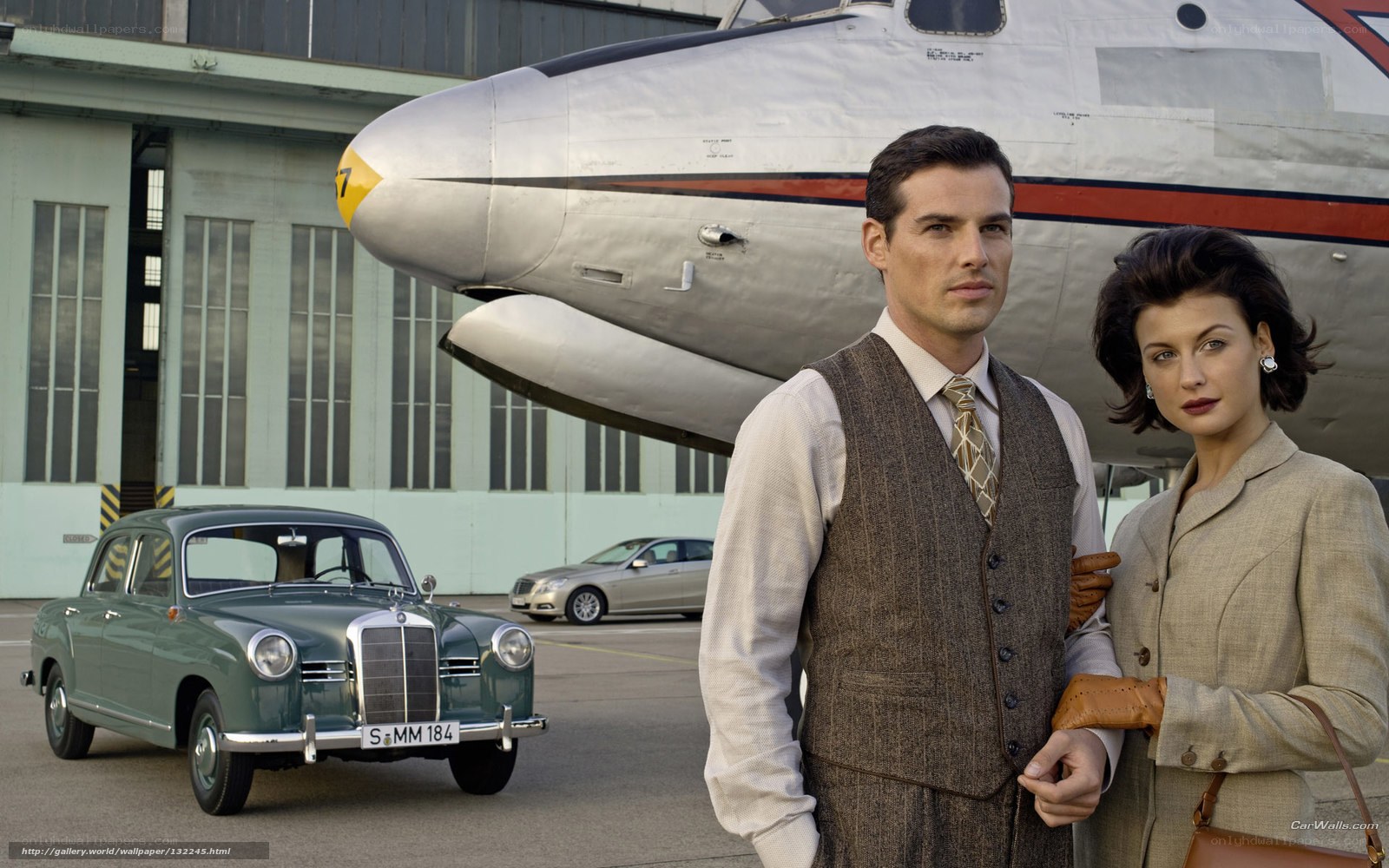Couple in front of vintage plane