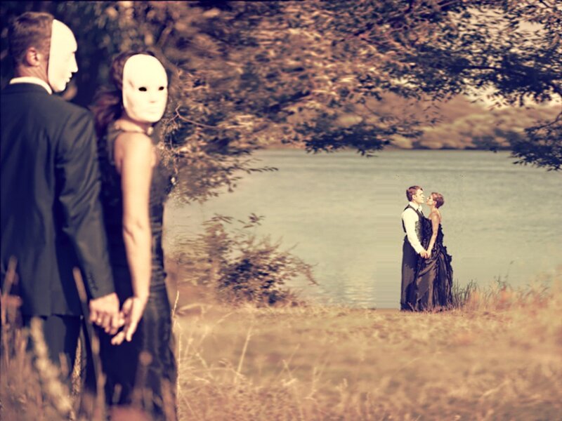 Couple in masks by the water