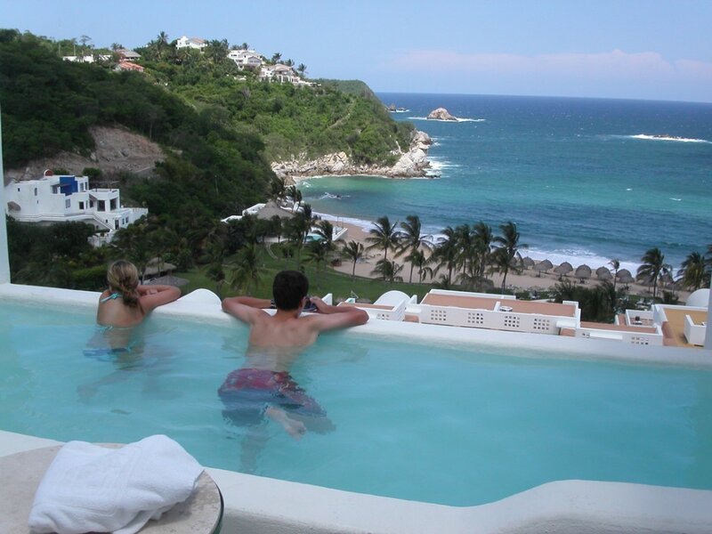 Couple in pool overlooking ocean