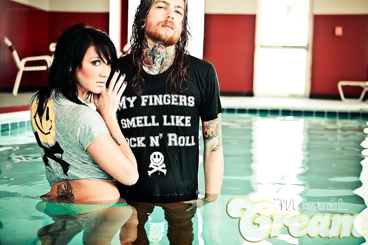 couple in pool with tattoos