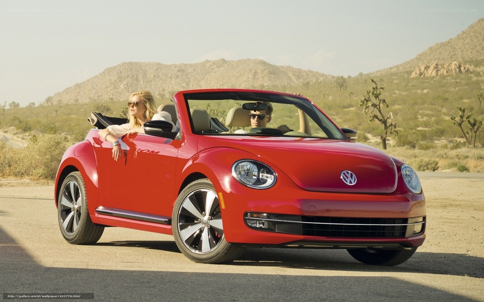 Couple in red convertible car