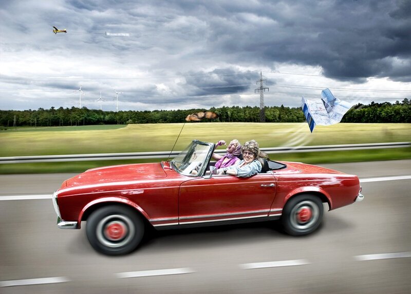 Couple in red convertible car