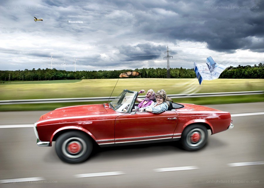 Couple in red convertible car