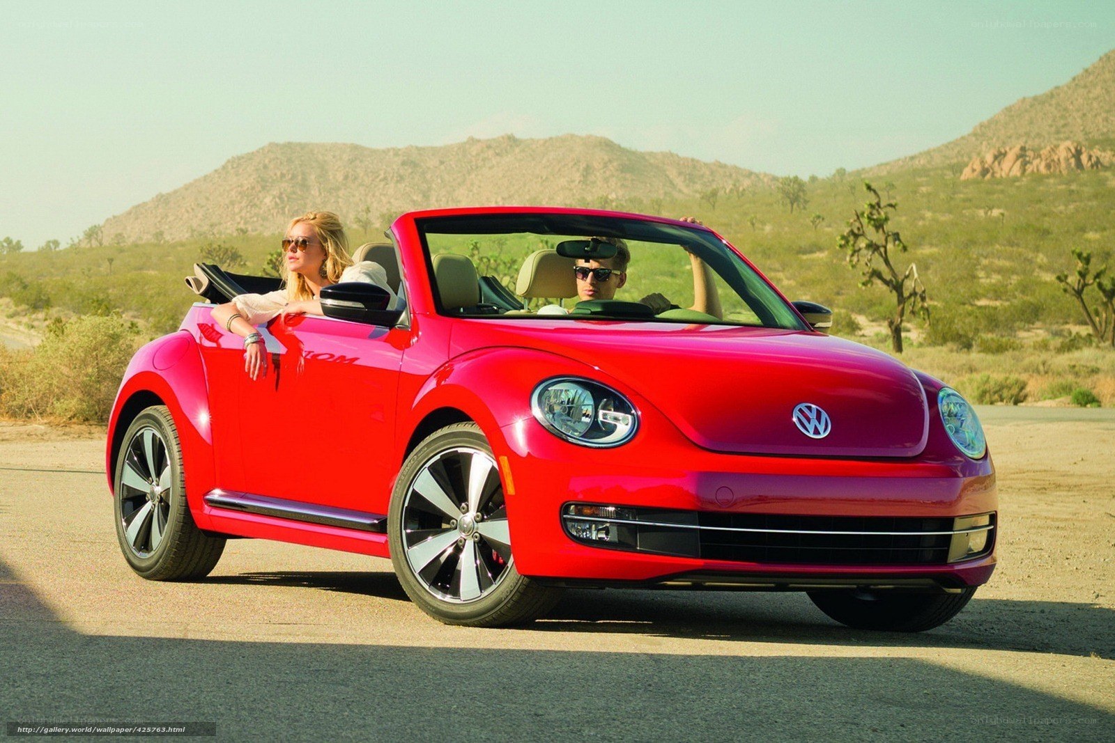 Couple in red convertible car