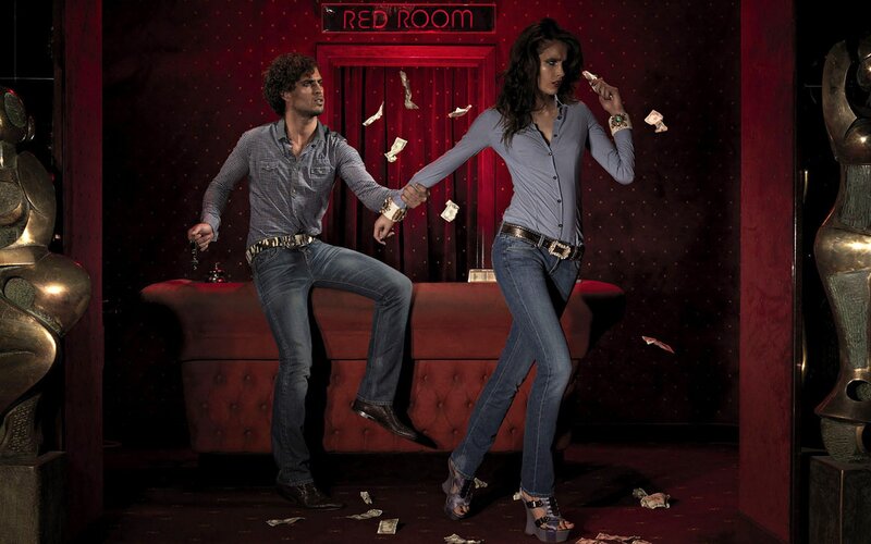 Couple in red room with money