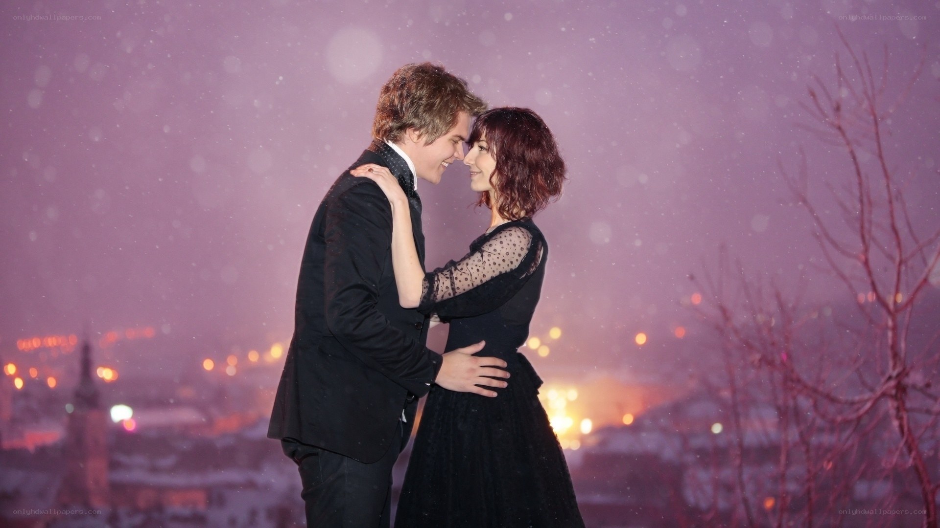 Couple in snow at night