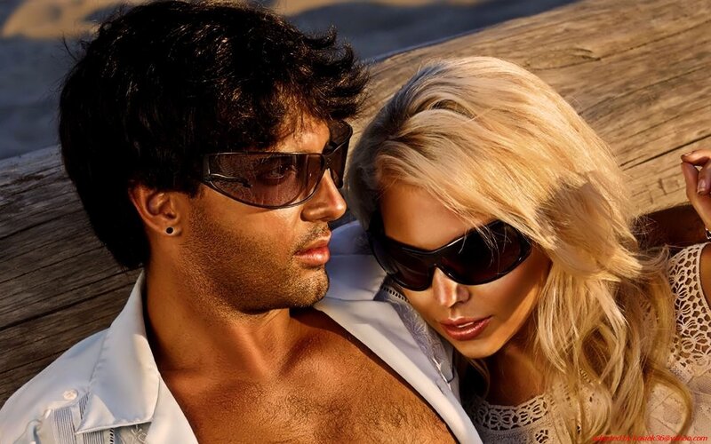 couple in sunglasses on wood