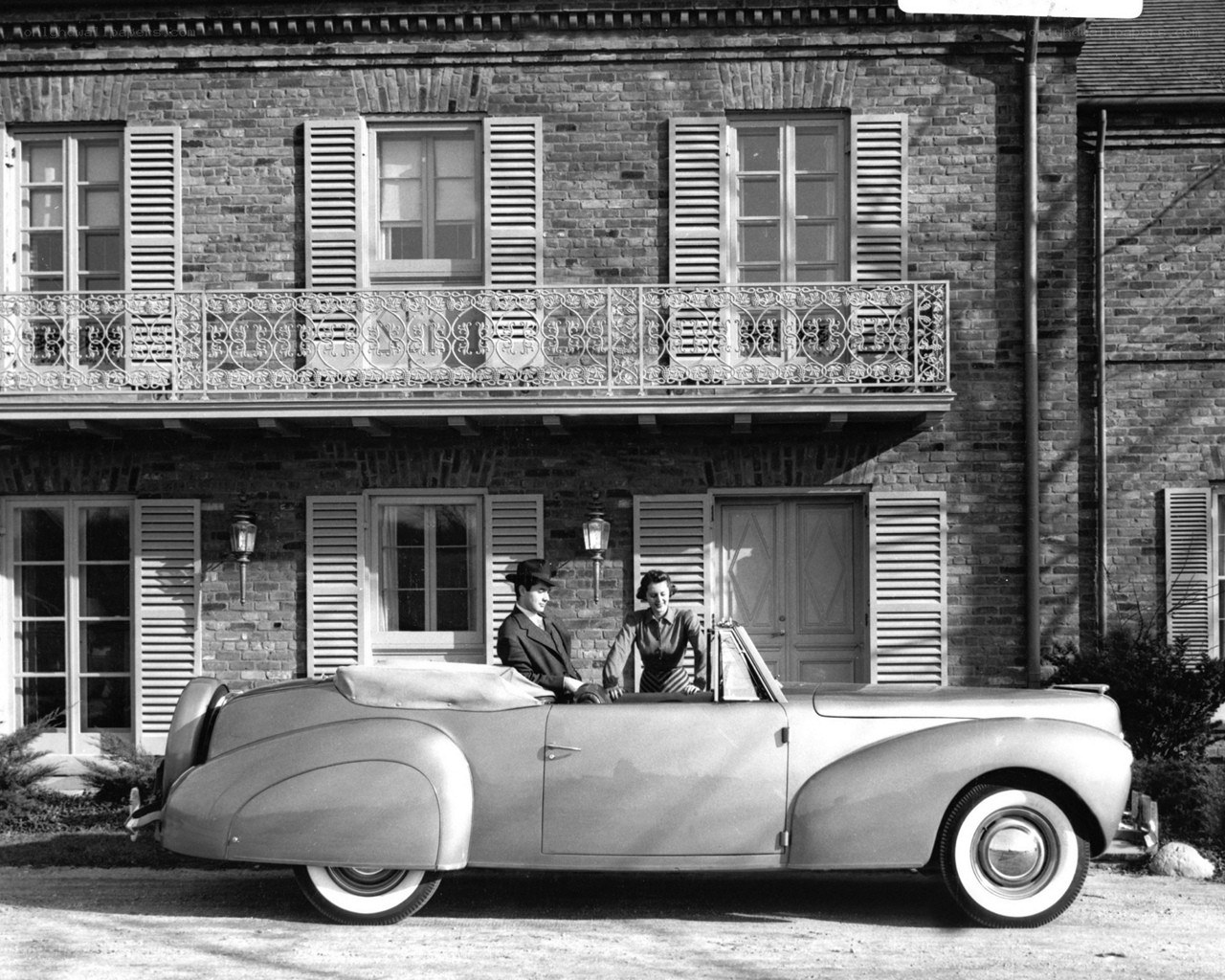 Couple in vintage convertible car