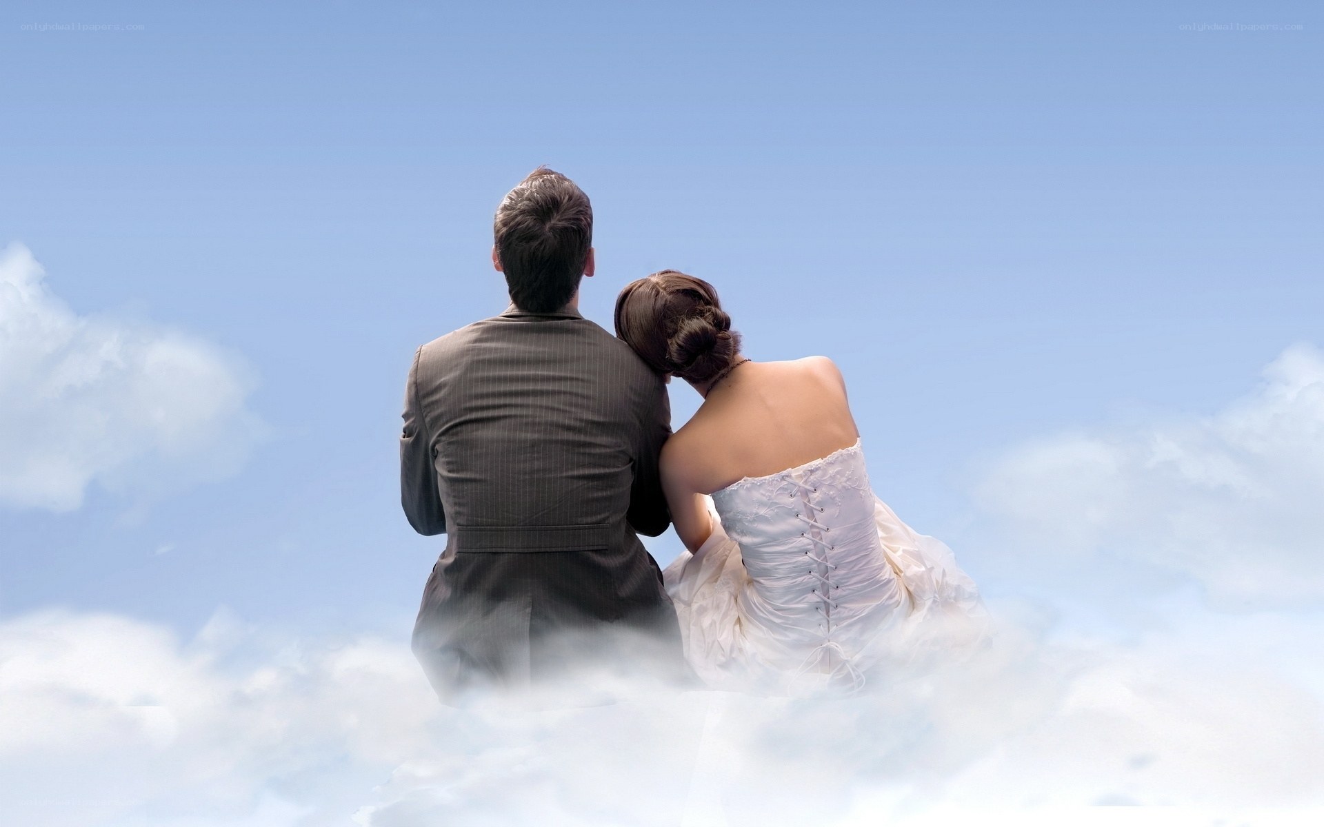Couple in wedding attire on clouds