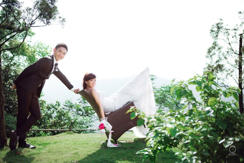 Couple in wedding attire outdoors
