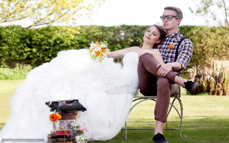 Couple in wedding attire outdoors