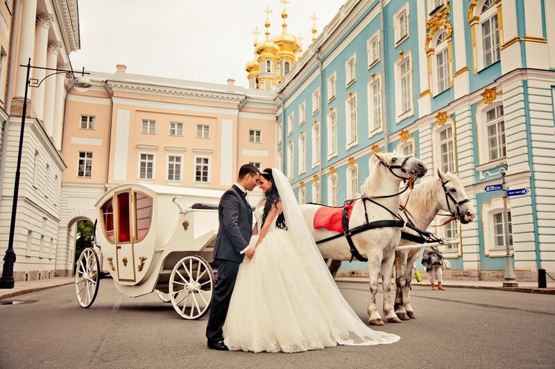 Couple in wedding attire with carriage