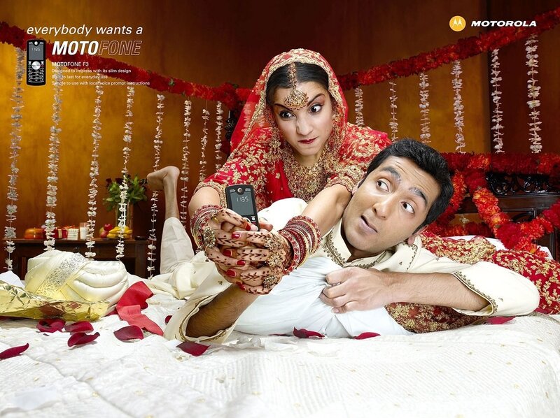 Couple in wedding attire with phone
