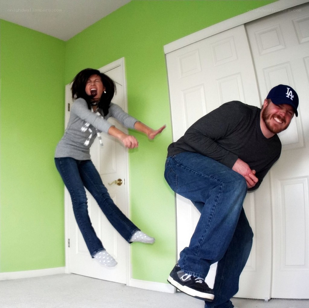 Couple jumping in a green room
