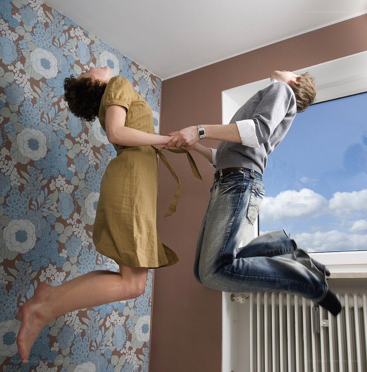 Couple jumping in room