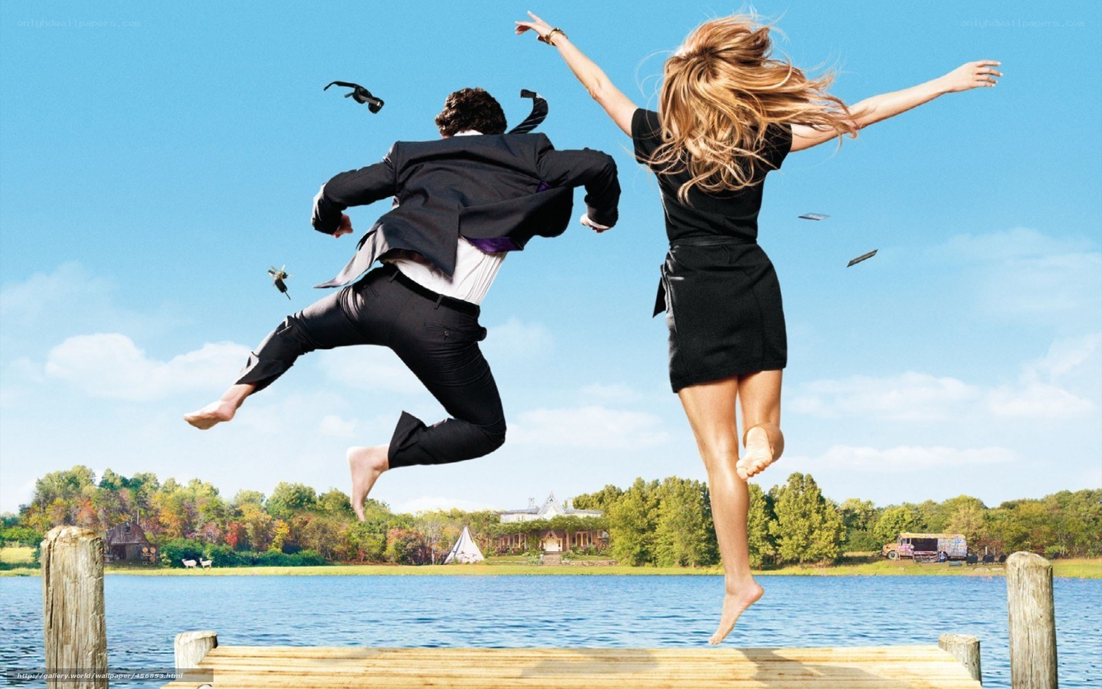 Couple jumping off dock